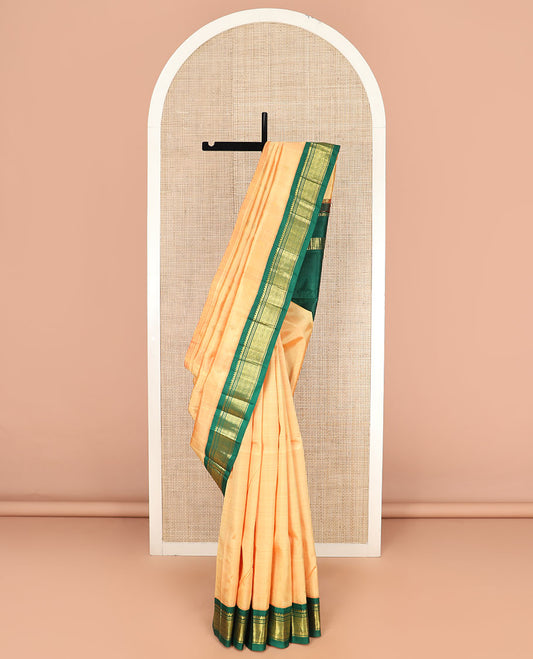 Orange Kanchipuram Silk Saree Sparsely Sparkled with Zari Buttas, Highlighted by Contrast One-Sided Korvai Border of Thilakam Mokku, Banaras, and Jaal Designs, Pallu Spotlighted with Zari Designs, and Comes Without a Blouse
