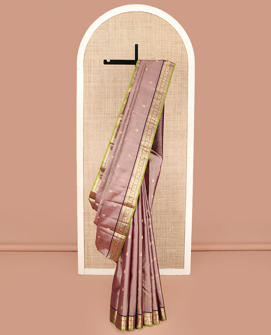 Rose Gold Pink Kanchipuram Silk Saree, Prettified with Zari Buttas All Over Its Body, Complemented by a Contrast Border of Mutthu, Mayil Kann, and Mayil Designs, Grandly Jaal Design Decked Up Pallu, and Paired with a Contrast Blouse