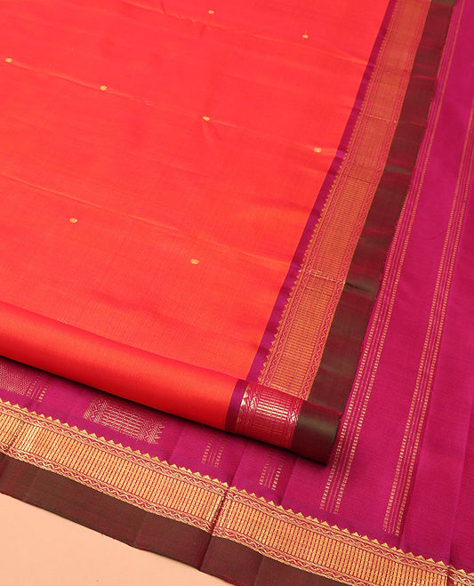 Orange Kanchipuram Silk Saree, Graced with Zari Buttas All Over Its Body, Complemented by Contrast Border of Rekku, Banaras, Neli, and Geometric Designs, Pallu of Traditional Designs, and Paired with a Contrast Blouse