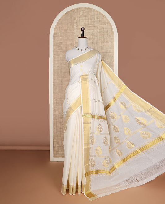 Cream zari buttas Kerala saree, zari border, and pallu of tree designs in zari