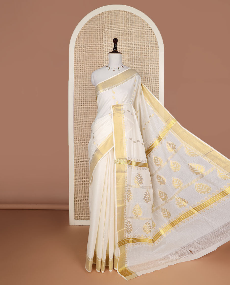 Cream zari buttas Kerala saree, zari border, and pallu of tree designs in zari