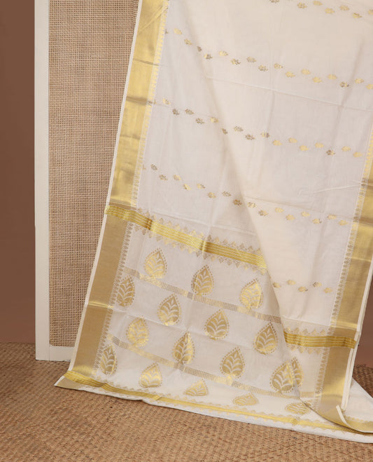 Cream zari buttas Kerala saree, zari border, and pallu of tree designs in zari