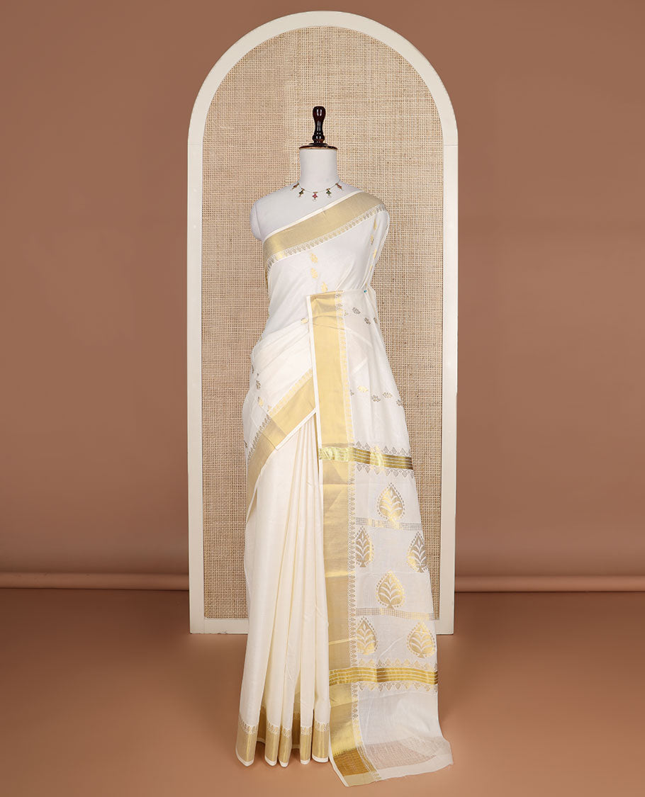 Cream zari buttas Kerala saree, zari border, and pallu of tree designs in zari