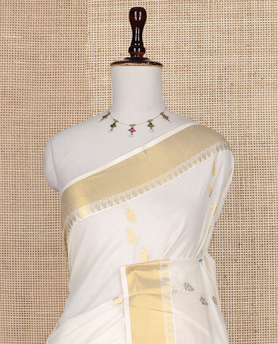 Cream zari buttas Kerala saree, zari border, and pallu of tree designs in zari