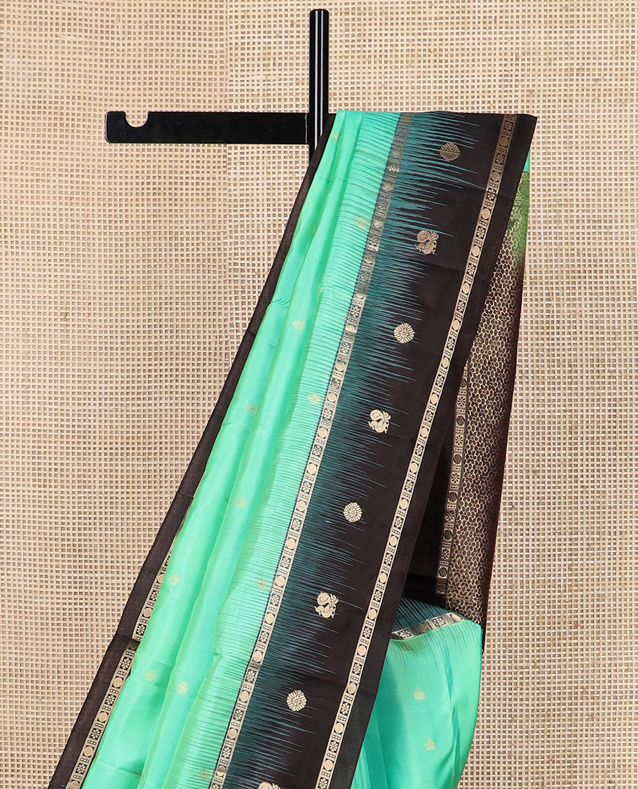 Turquoise zari buttas soft silk saree, contrast border of mayil chakram & kamalam designs & pallu of floral designs