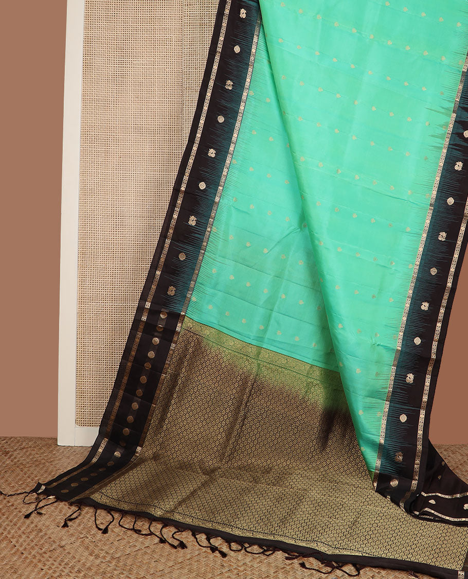 Turquoise zari buttas soft silk saree, contrast border of mayil chakram & kamalam designs & pallu of floral designs