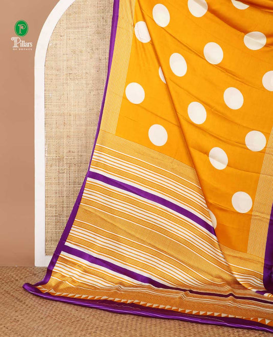 Cream with orange polka dot printed gajji silk saree with contrast piping border & printed pallu along with striped printed blouse