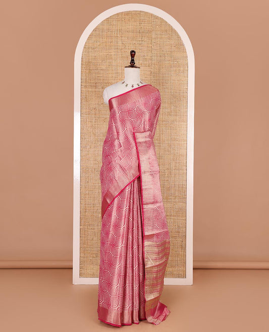 Rani pink scallop design tissue saree, zari striped border, striped pallu, and gleaming matching blouse