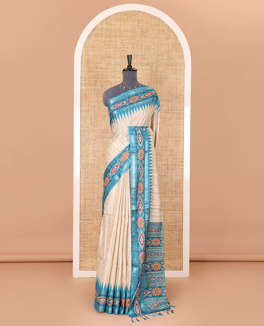 Chikku- blue plain Katan silk saree, contrast ikkat floral-geometric printed temple border, ikkat printed pallu, and ikkat printed blouse