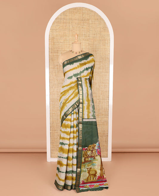 Mehendi green shibori printed muslin cotton saree, contrast peacock zari border, village scenery printed pallu, and a contrast polka dotted zari border blouse