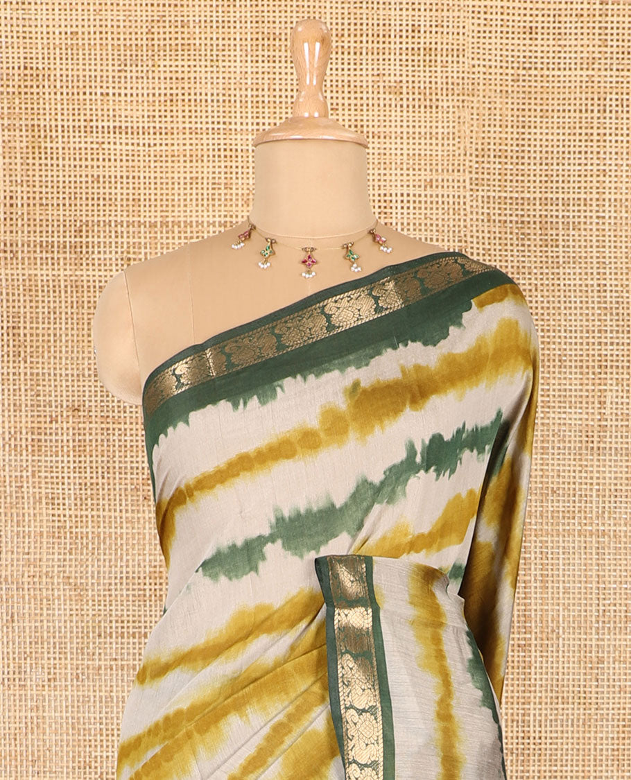 Mehendi green shibori printed muslin cotton saree, contrast peacock zari border, village scenery printed pallu, and a contrast polka dotted zari border blouse