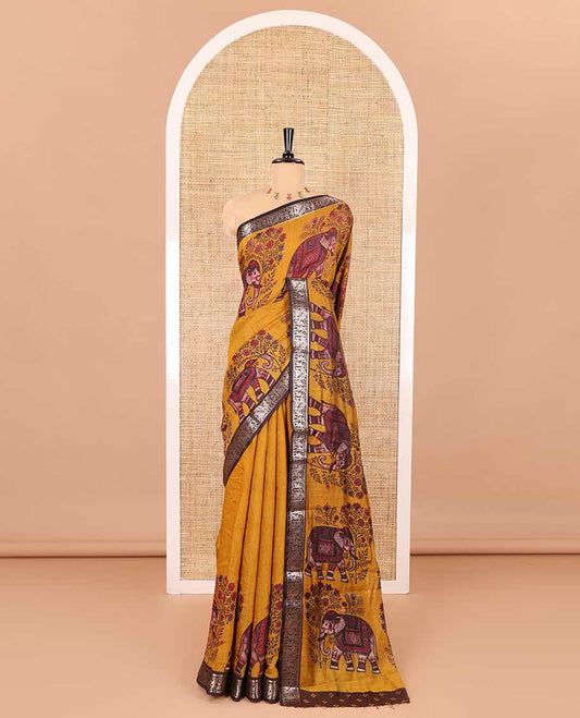 Mustard plain muslin cotton saree, contrast wedding-theme of floral and elephant motifs print, printed pallu, and a contrast buttas and zari bordered blouse