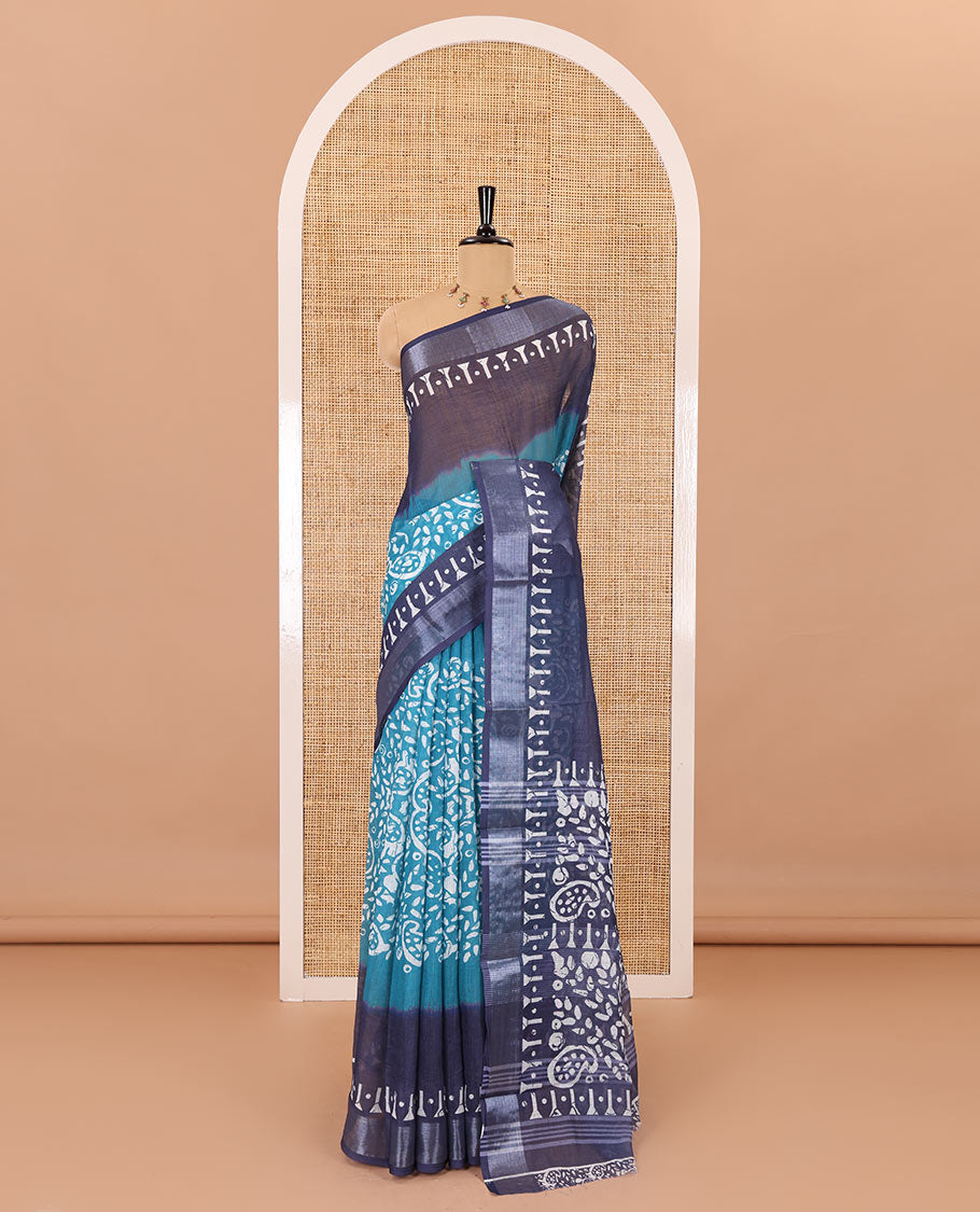 Blue batik style paisleys printed linen cotton saree, contrast batik printed with zari border, batik paisleys printed pallu, and a contrast printed blouse