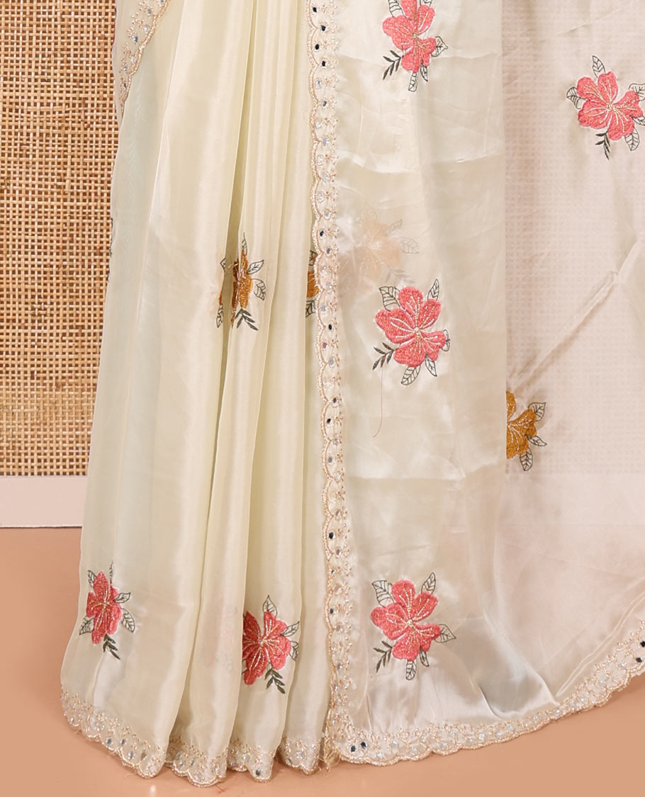 Cream floral motifs embroidered rangoli chiffon saree with mirror work border, embroidered pallu, and a contrast intricate scallop design embroidered blouse