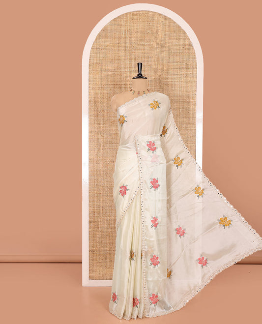 Cream floral motifs embroidered rangoli chiffon saree with mirror work border, embroidered pallu, and a contrast intricate scallop design embroidered blouse