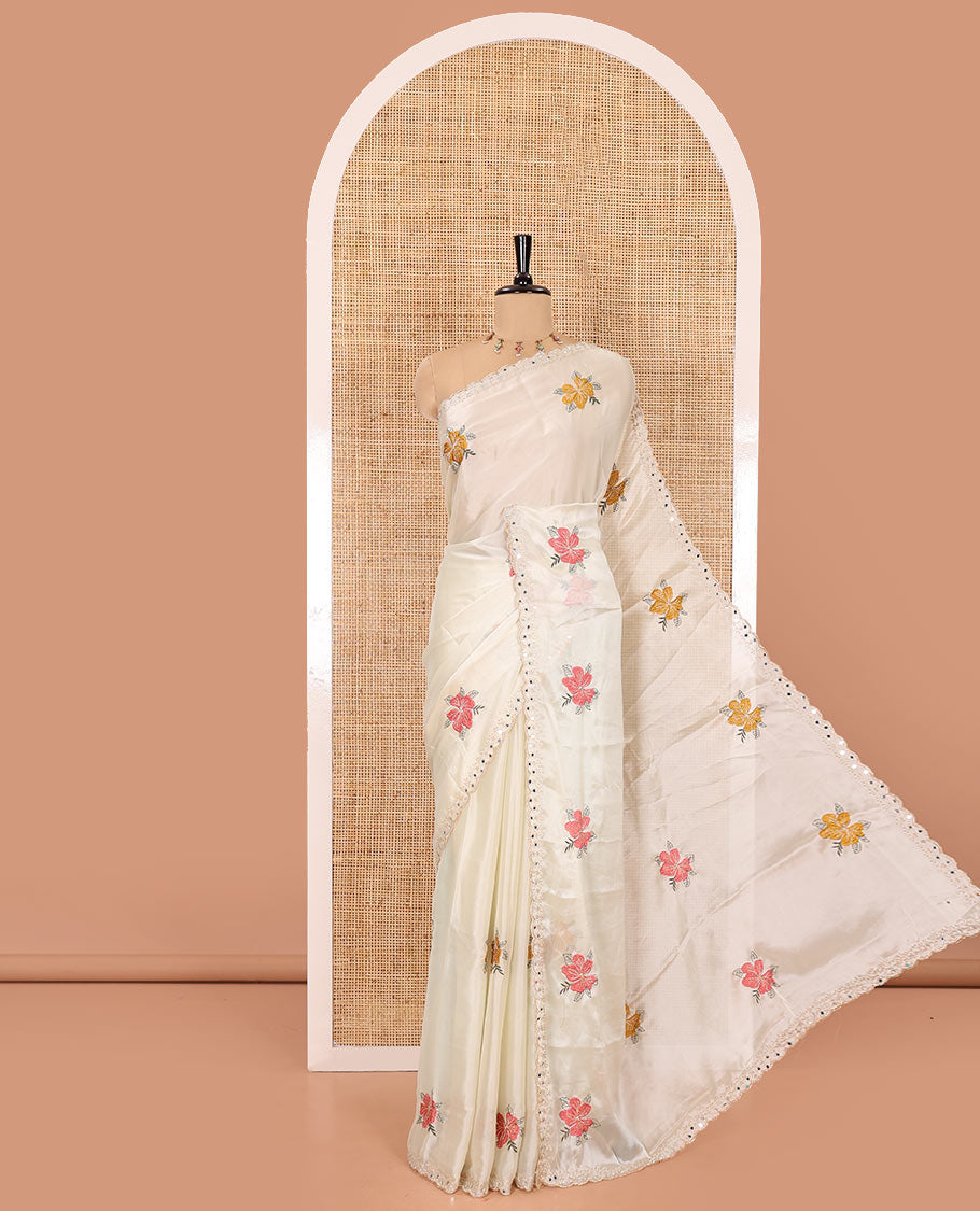 Cream floral motifs embroidered rangoli chiffon saree with mirror work border, embroidered pallu, and a contrast intricate scallop design embroidered blouse