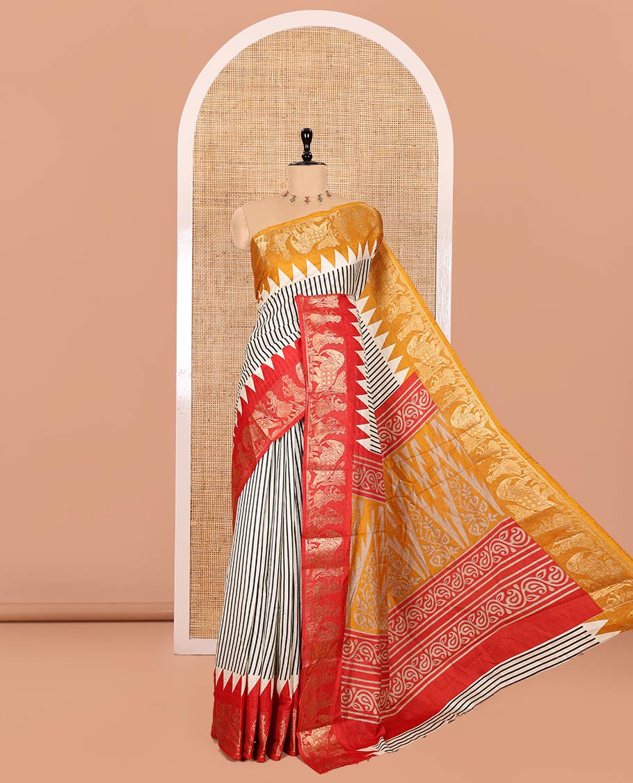 Chikku Base Dola Silk Saree Subtly Sparkled with Black Stripes All Over Its Body, Complemented by a Contrast Ganga-Jamuna Border of Human Figurines and Elephant Motifs, Pallu of Floral-Paisley Print, and Paired with a Contrast Blouse
