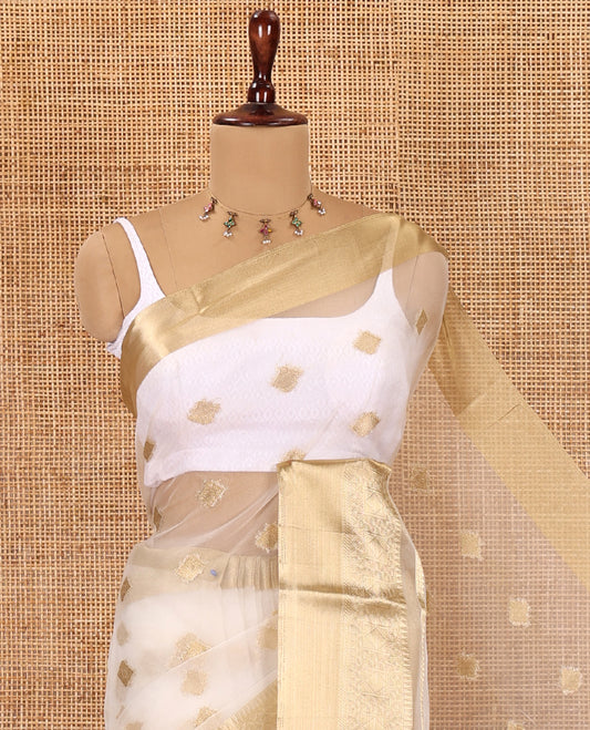 Cream Semi-Organza Saree, Subtly Enriched with Zari Buttas, Highlighted by a Zari Traditional Border, and a Matching Blouse