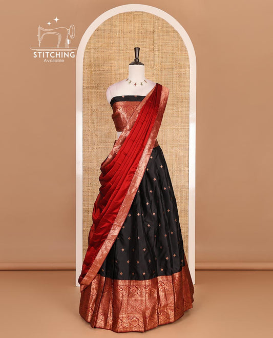 Black taffeta silk half saree, zari buttas with contrast red traditional zari border, matching zari blouse, and contrast plain zari border dhavani