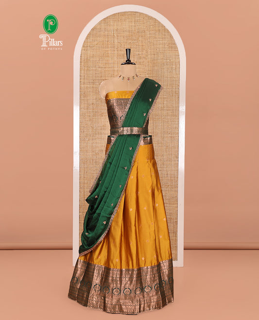 Yellow and Green Semi-Banarasi Half-Saree Prettified with Zari Buttas on Its Skirt, Complemented by a Contrast Traditional Zari Design Steeped Border, Paired with a Matching Blouse, and a Satin Georgette Embroidered Scallop Dhavani