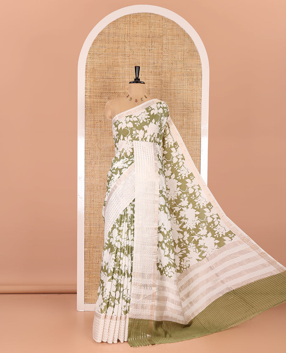 Olive green silhouette-style floral discharge printed Assam silk saree, contrast traditional zari border of rudraksham motifs, zari striped pallu, and a floral printed blouse