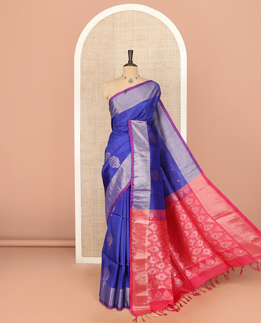 Blue Semi Uppada Saree Gracefully Embellished with Zari Buttas, Complemented by a Contrasting Bavanji Border, Pallu of Intricate Ogee Designs, and Paired with a Contrast Blouse