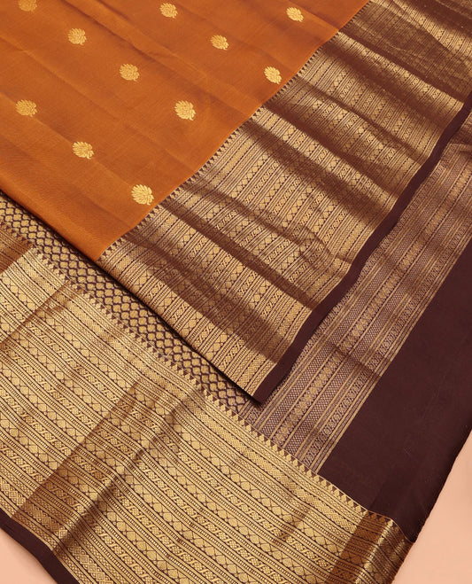 Mustard Vasundhara Lite Silk Mix Saree Elegantly Framed with Zari Buttas, Complemented by a Contrast Border of Thilakam Mokku, Banaras, Mayil Kann, Rekku, and Cross Kamalam Designs, Zari Elevated Pallu, and a Contrast Blouse