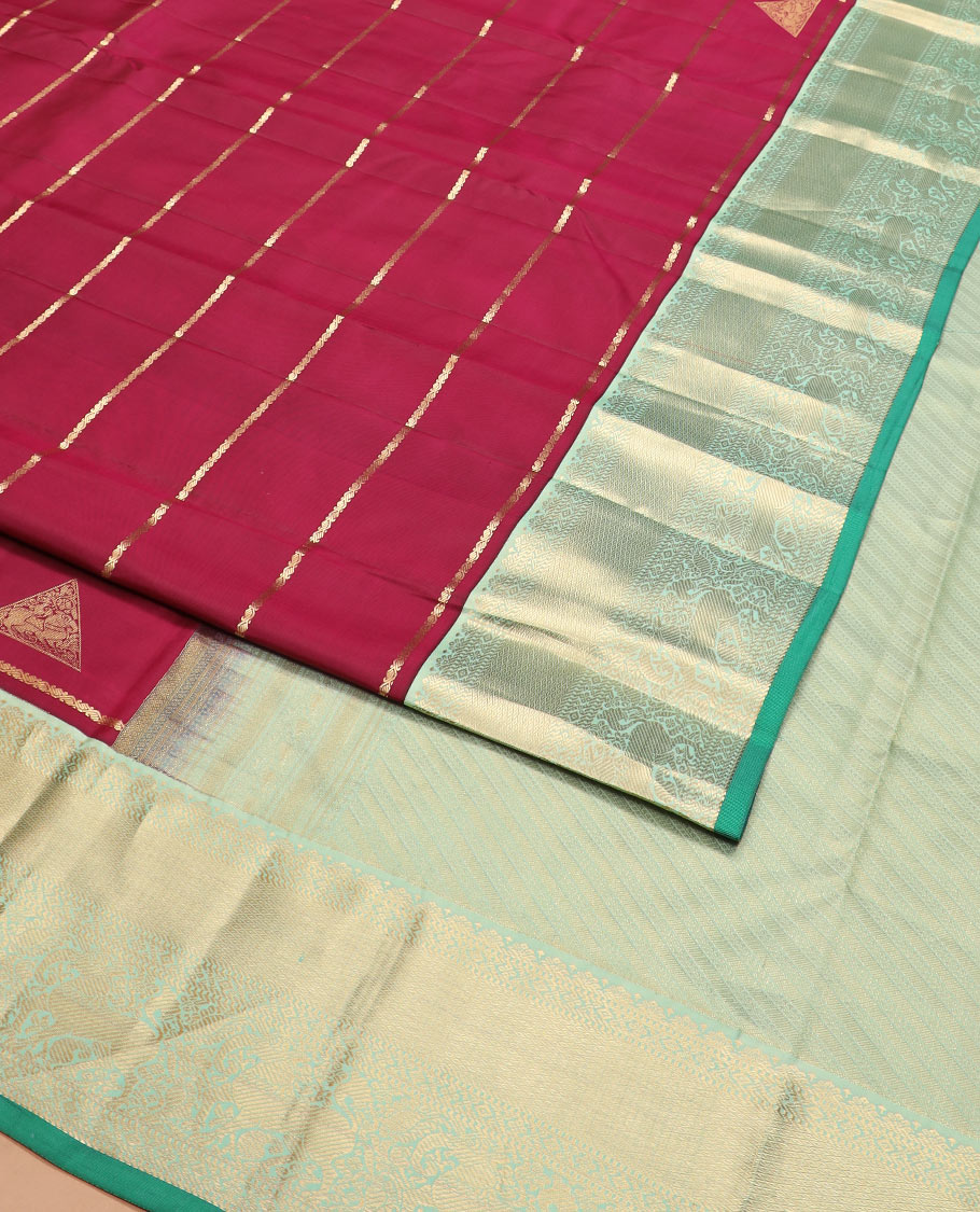 Maroon zari buttas silk saree, contrast border of yaali designs, and pallu of diagonal stripes