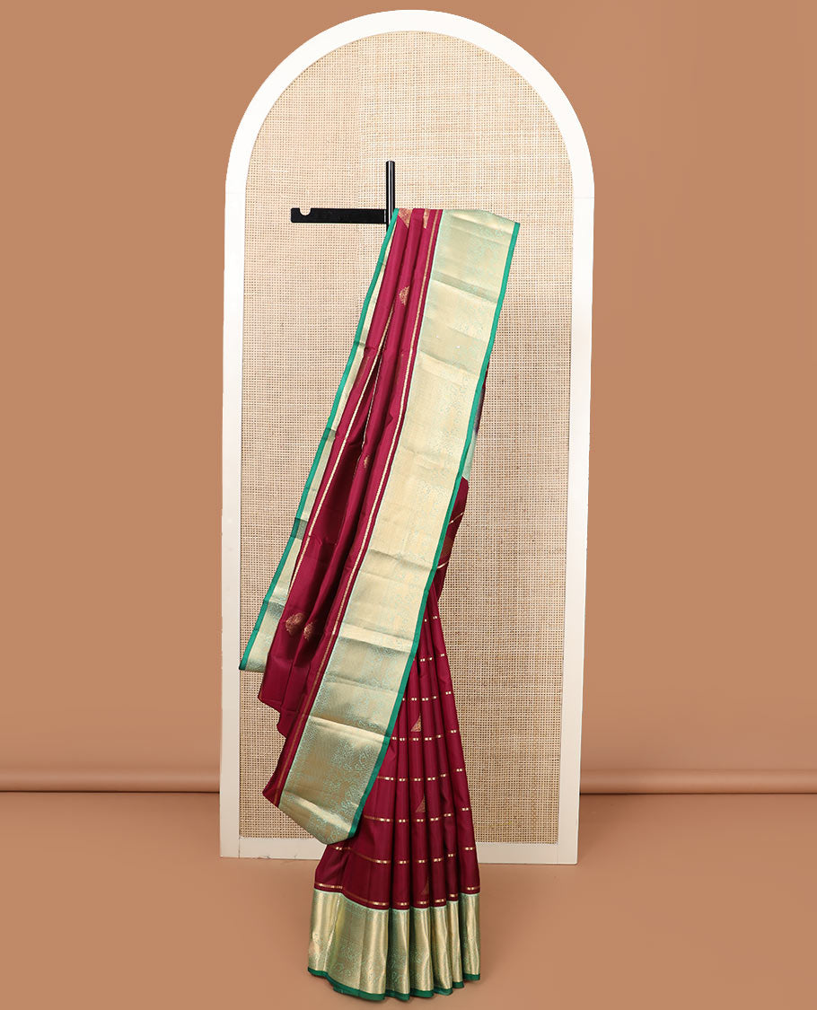 Maroon zari buttas silk saree, contrast border of yaali designs, and pallu of diagonal stripes