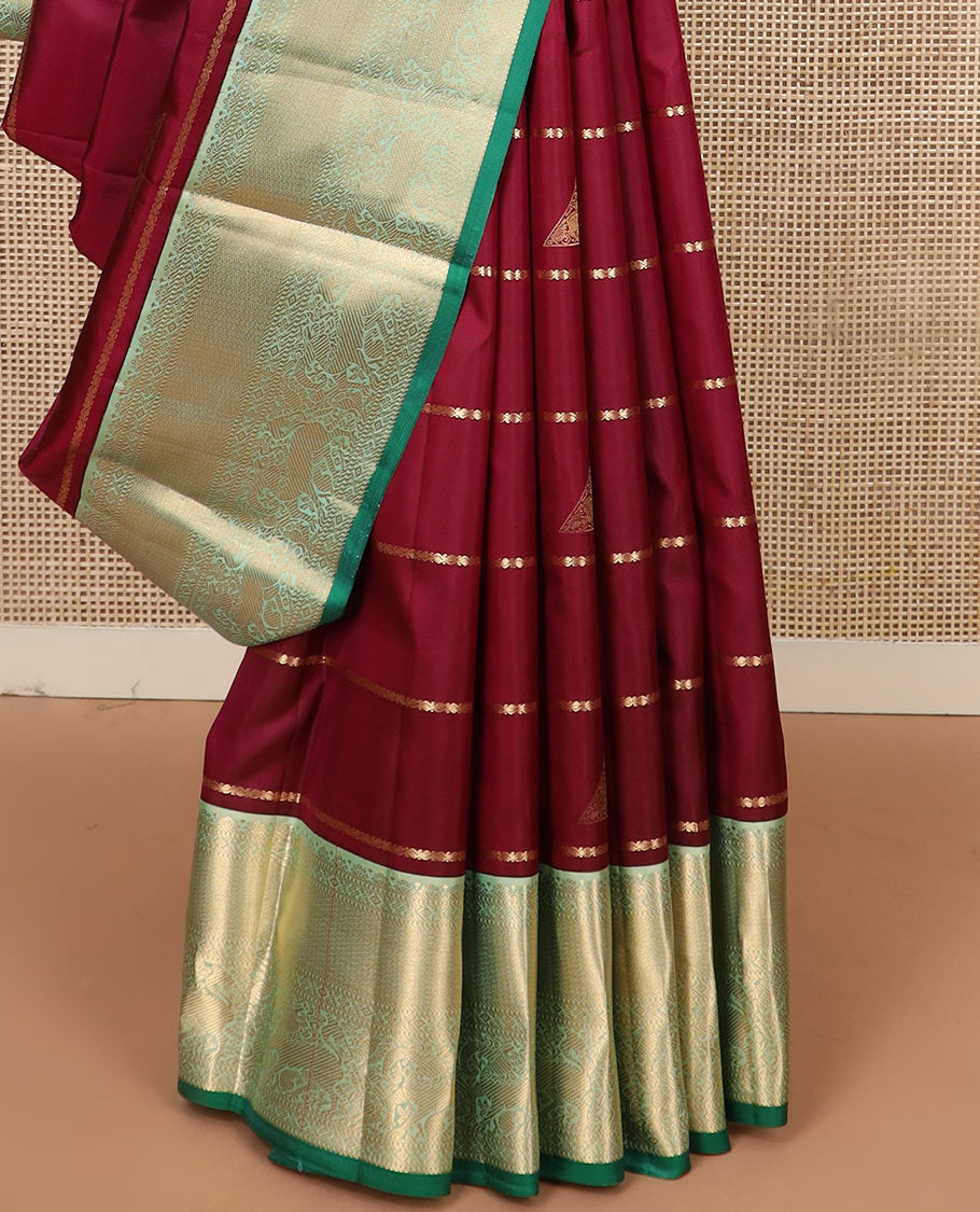 Maroon zari buttas silk saree, contrast border of yaali designs, and pallu of diagonal stripes
