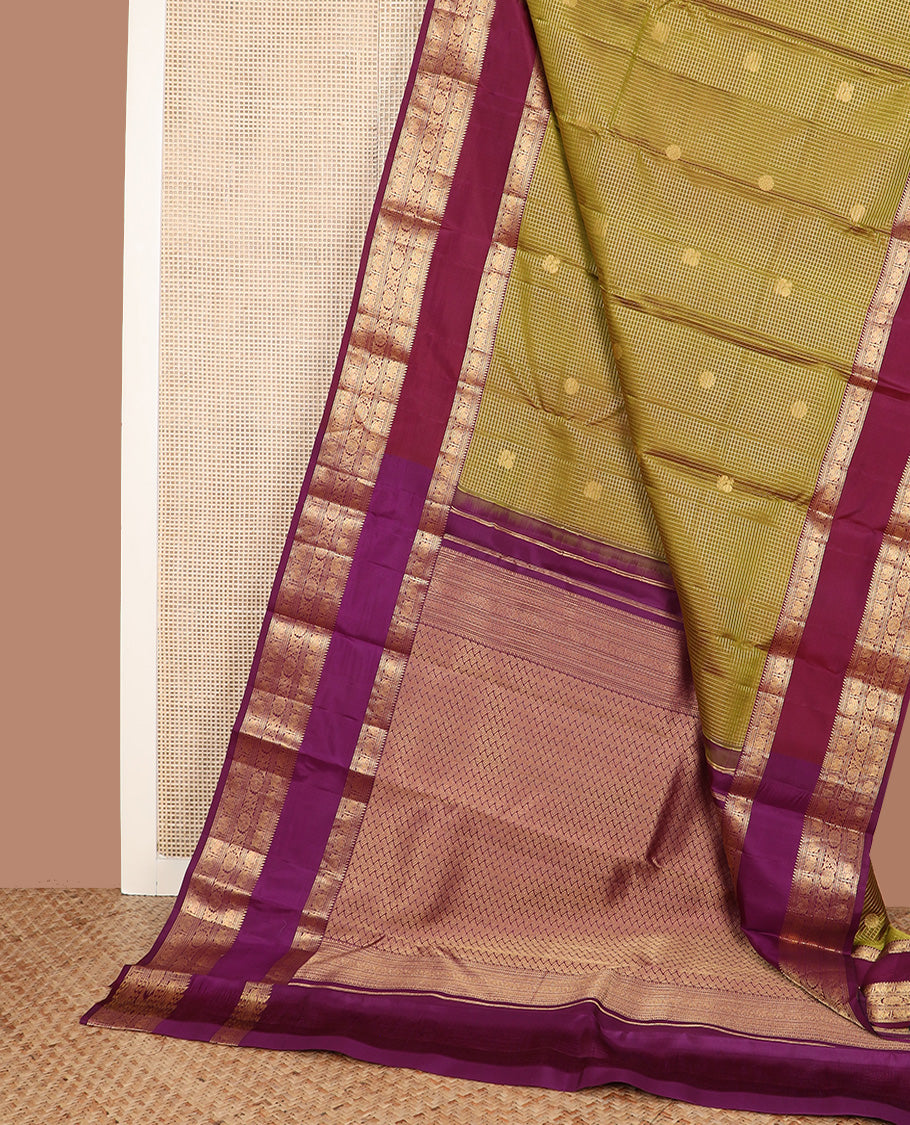 Green micro-checked with annam chakram buttas silk saree, contrast rettai pettu border of ara bogudi, muthu, banaras,iruthalai pakshi and poo chakram, and jaal pallu