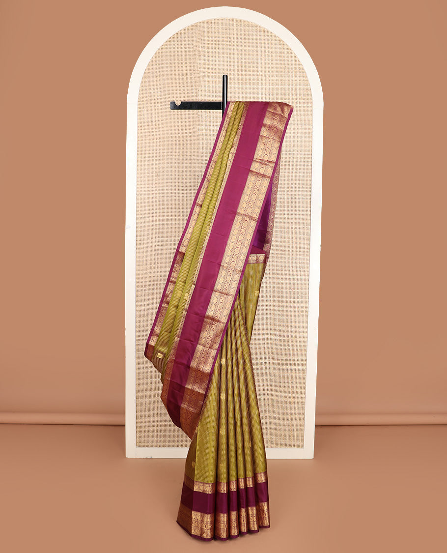 Green micro-checked with annam chakram buttas silk saree, contrast rettai pettu border of ara bogudi, muthu, banaras,iruthalai pakshi and poo chakram, and jaal pallu
