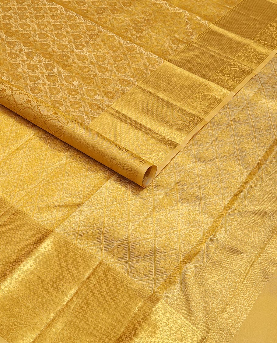 Yellow jacquard kanchipuram wedding silk saree, zari border of traditional design & pallu of floral motif enclosed jaal design
