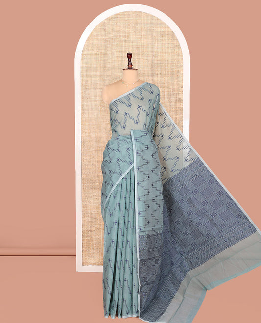 Borderless Blue Semi-Silk Cotton Saree, Delicately Designed with Unique Buttas on Its Body, Highlighted by Geometric-Patterned Pallu, and Paired with a Matching Blouse