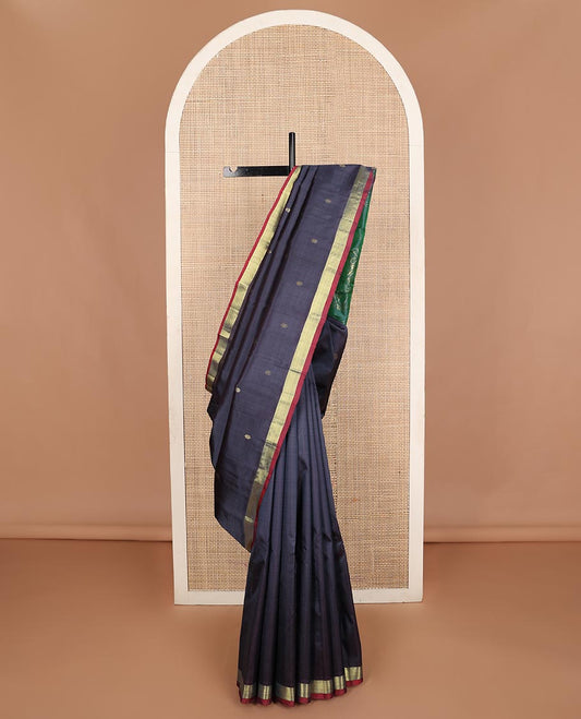 Dark blue zari buttas Kanchipuram silk saree, contrast bavanji border, and floral zari design pallu