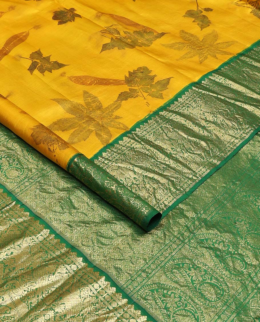 Yellow floral printed silks saree, contrast zari border of rudraksham, banaras, mayil, yaanai, and yaali designs, and jaal pallu