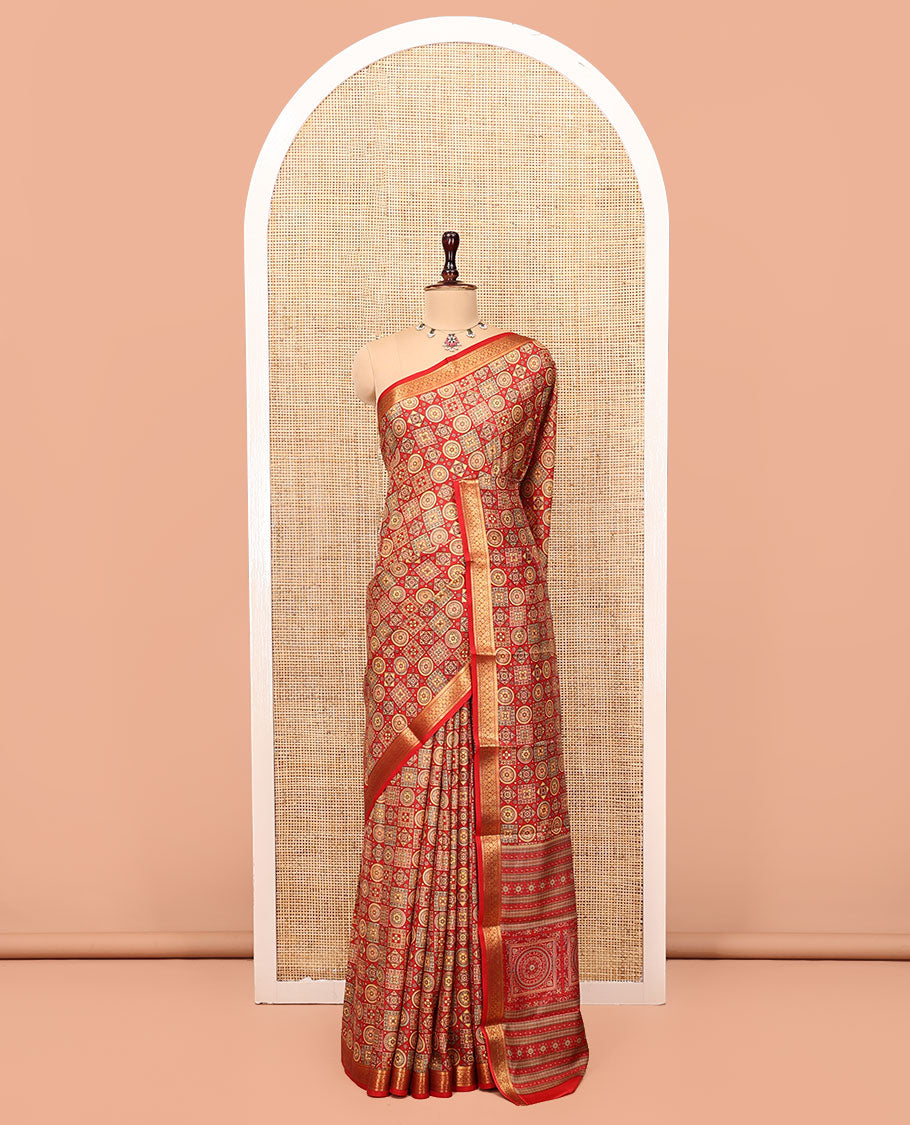 Red Printed Silk Saree, Gracefully Embellished with Geometric Prints, Highlighted by a Traditional Zari Border, Printed Pallu, and a Matching Blouse
