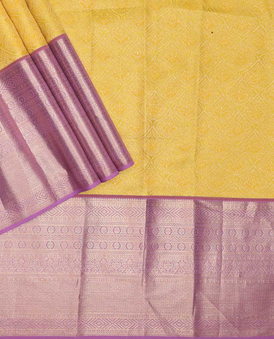 Yellow pure silk half-saree,  jacquard skirt, contrast border of thilakam mokku,banaras, mayil kann,cross kamalam, and then kuli kann , contrast zari blouse, and zari design dhavani