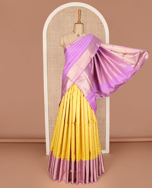 Yellow pure silk half-saree,  jacquard skirt, contrast border of thilakam mokku,banaras, mayil kann,cross kamalam, and then kuli kann , contrast zari blouse, and zari design dhavani
