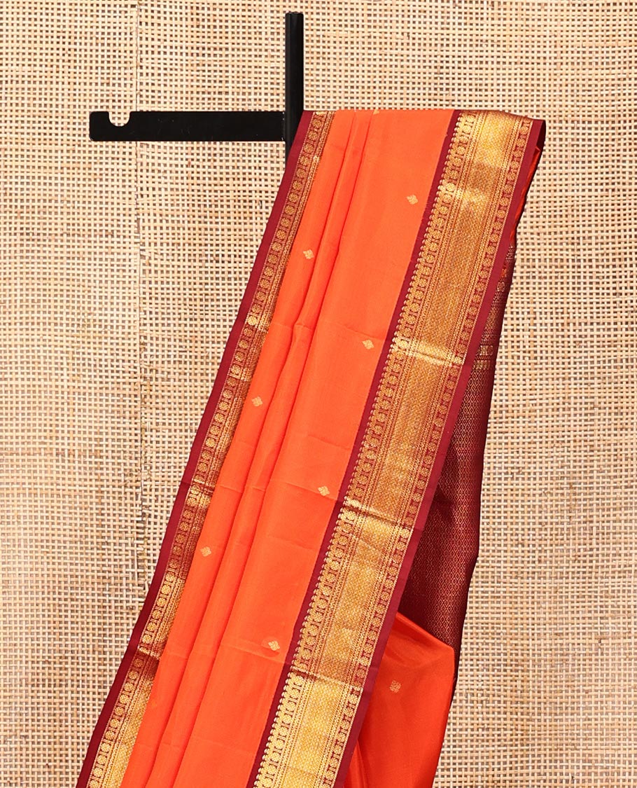 Orange Vasundhara Silk Saree, Enthralled with Zari Buttas All Over Its Body, Complemented by a Contrast Border of Manga, Poun, Neli, and Mayil Kann Designs, Grand Jaal Pallu, and Paired with a Contrast Blouse