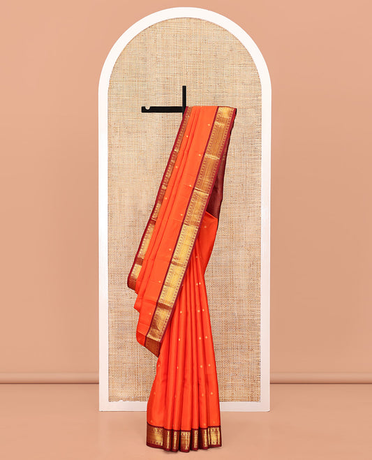 Orange Vasundhara Silk Saree, Enthralled with Zari Buttas All Over Its Body, Complemented by a Contrast Border of Manga, Poun, Neli, and Mayil Kann Designs, Grand Jaal Pallu, and Paired with a Contrast Blouse