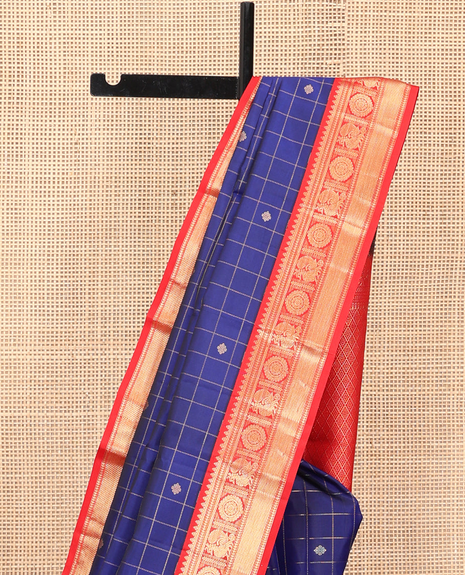 Blue Vasundhara Silk Saree, Adorned with Butta Enclosed Checks, Complemented by a Contrast Border of Mayil Chakram Designs, and a Contrast Blouse