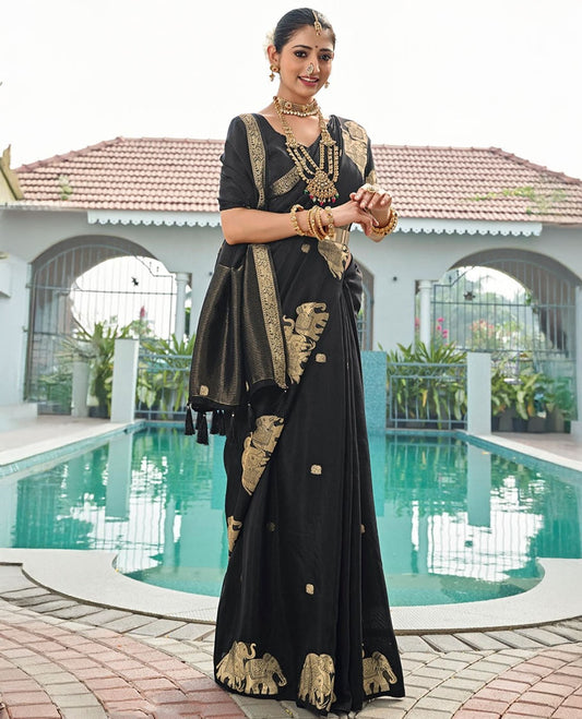 Black Designer Saree, Gracefully Embellished with Zari Buttas, Featuring a Self-Border Depicting a Herd of Elephants, Subtly Woven Pallu of Spare Stripes, and Paired with a Matching Blouse of Elephant Motifs
