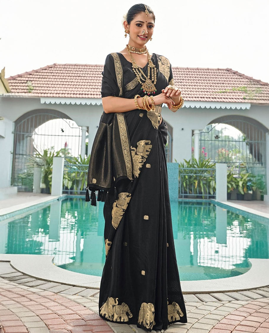Black Designer Saree, Gracefully Embellished with Zari Buttas, Featuring a Self-Border Depicting a Herd of Elephants, Subtly Woven Pallu of Spare Stripes, and Paired with a Matching Blouse of Elephant Motifs