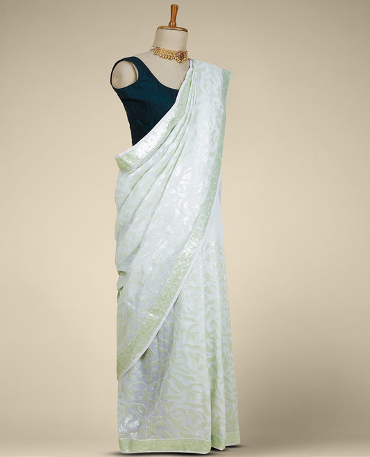 Pastel green georgette saree with floral vine designs sequins embroidered all over its body & pallu, sequins work border