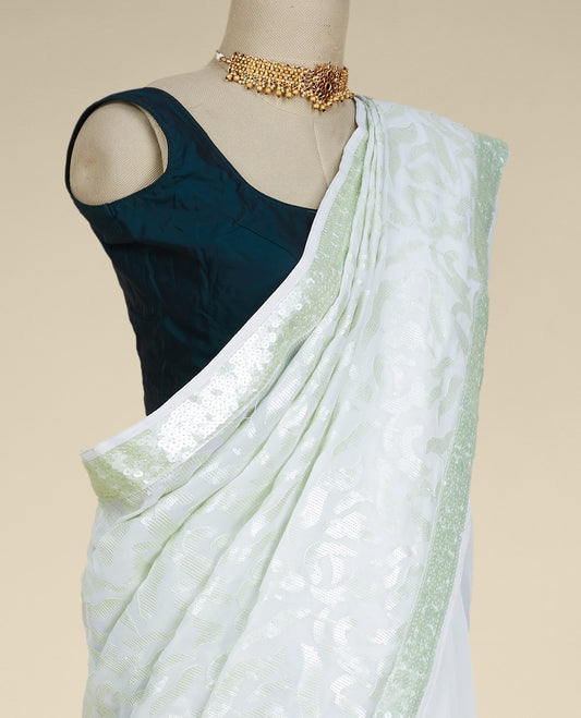 Pastel green georgette saree with floral vine designs sequins embroidered all over its body & pallu, sequins work border
