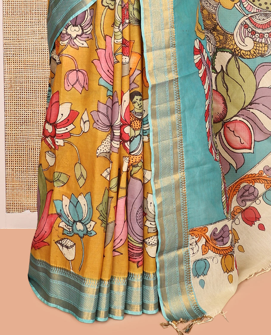 Gold Kalamkari Silk Saree, Impeccably Styled with Floral Vine and Human Motifs Print, a Contrast Traditional Zari Border, Pallu Features Peacocks, and a Contrast Blouse