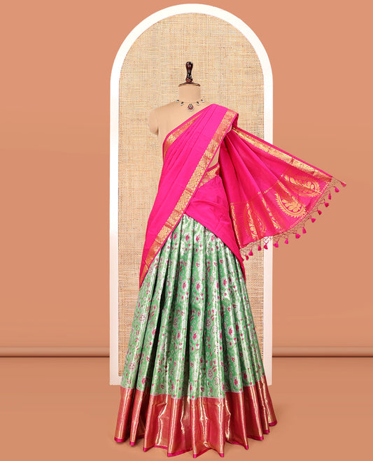 Green Art Silk Material Half Saree, Spotlighted with Jacquard Skirt, a Contrast Traditional Zari Border, Contrast Blouse, and an Intricate Dhavani