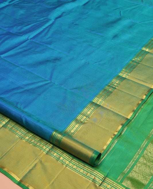 Blue Plain Kanchipuram Silk Saree, Complemented by a Contrast Rettai Pettu Border of Rekku, Banaras, Rudraksham, and Star Designs, Zari Striped Pallu, and Paired with a Contrast Blouse