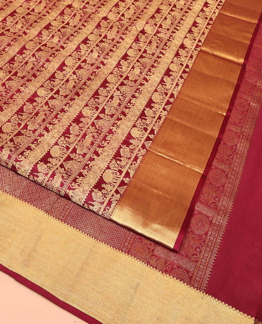 Maroon Kanchipuram Wedding Silk Saree, Artfully Woven with Warli Village Theme Motifs in Jacquard Weave, Highlighted by Thick Zari Border, Grand Jaal Pallu and Paired with a Matching Blouse